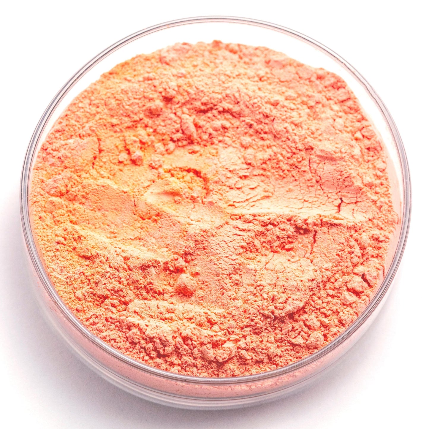 A glass container filled with a reddish-orange powder substance.