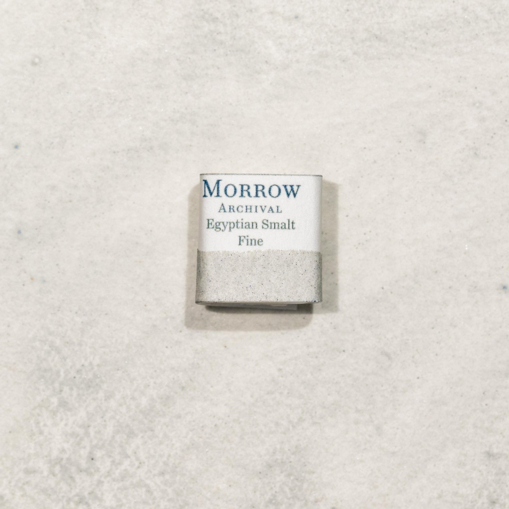 Watercolor painting with a handmade archival watercolor pan with elegant and vibrant label in watercolor paper in Egyptian Fine Smalt, a luminous blue pigment made from ground potassium glass following an ancient Egyptian recipe, lower in cobalt than later European smalts, yielding a softer, sky-toned hue. Handcrafted with honey and gum arabic. Semi-transparent and moderately lightfast, ideal for ancient recreations, fresco-style work, and soft celestial tones in historical palettes.