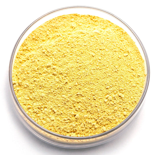 A clear glass bowl filled with a yellow substance, possibly a powder or granular material.