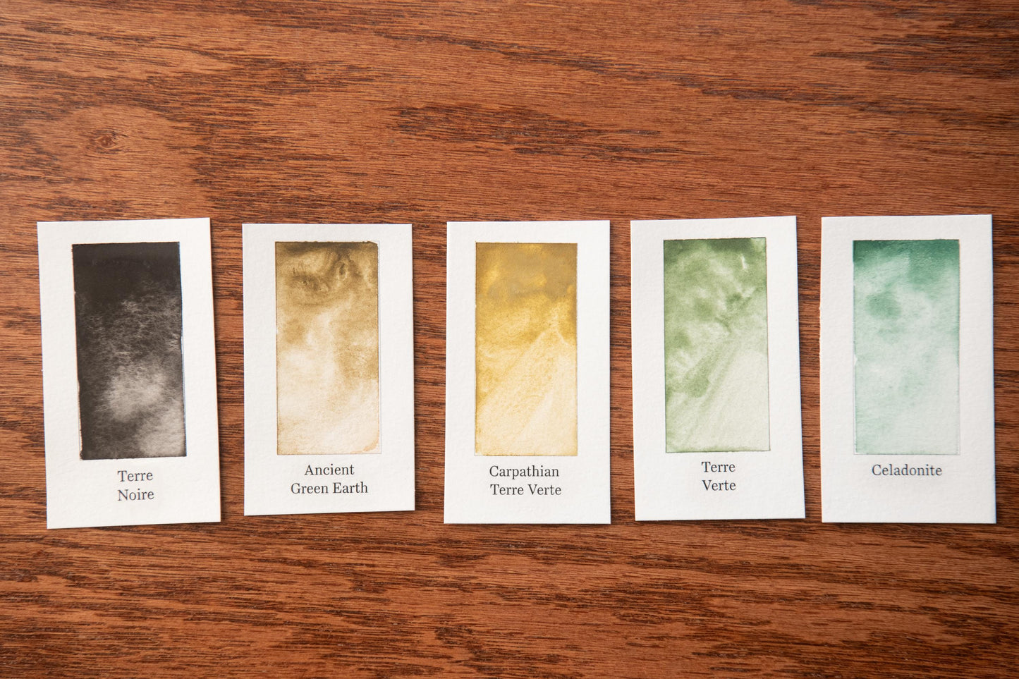 five cards, each displaying a different color of Terre Noire, Ancient Green Earth, Carpathian Terre Verte, Terre Verte, and Celestone.
