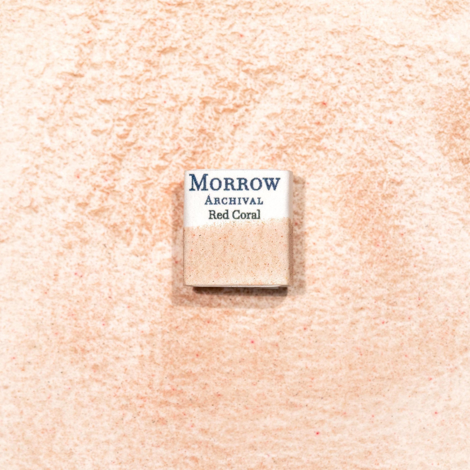 Watercolor painting with a handmade archival watercolor pan with elegant and vibrant label in watercolor paper in Natural Marine Red Coral, a vivid organic pigment derived from sustainably sourced marine coral, prized in antiquity for its striking red hues and talismanic properties. Handcrafted with honey and gum arabic. Semi-transparent and moderately lightfast, ideal for illuminated manuscripts, Renaissance revival palettes, and jewel-toned botanical accents.