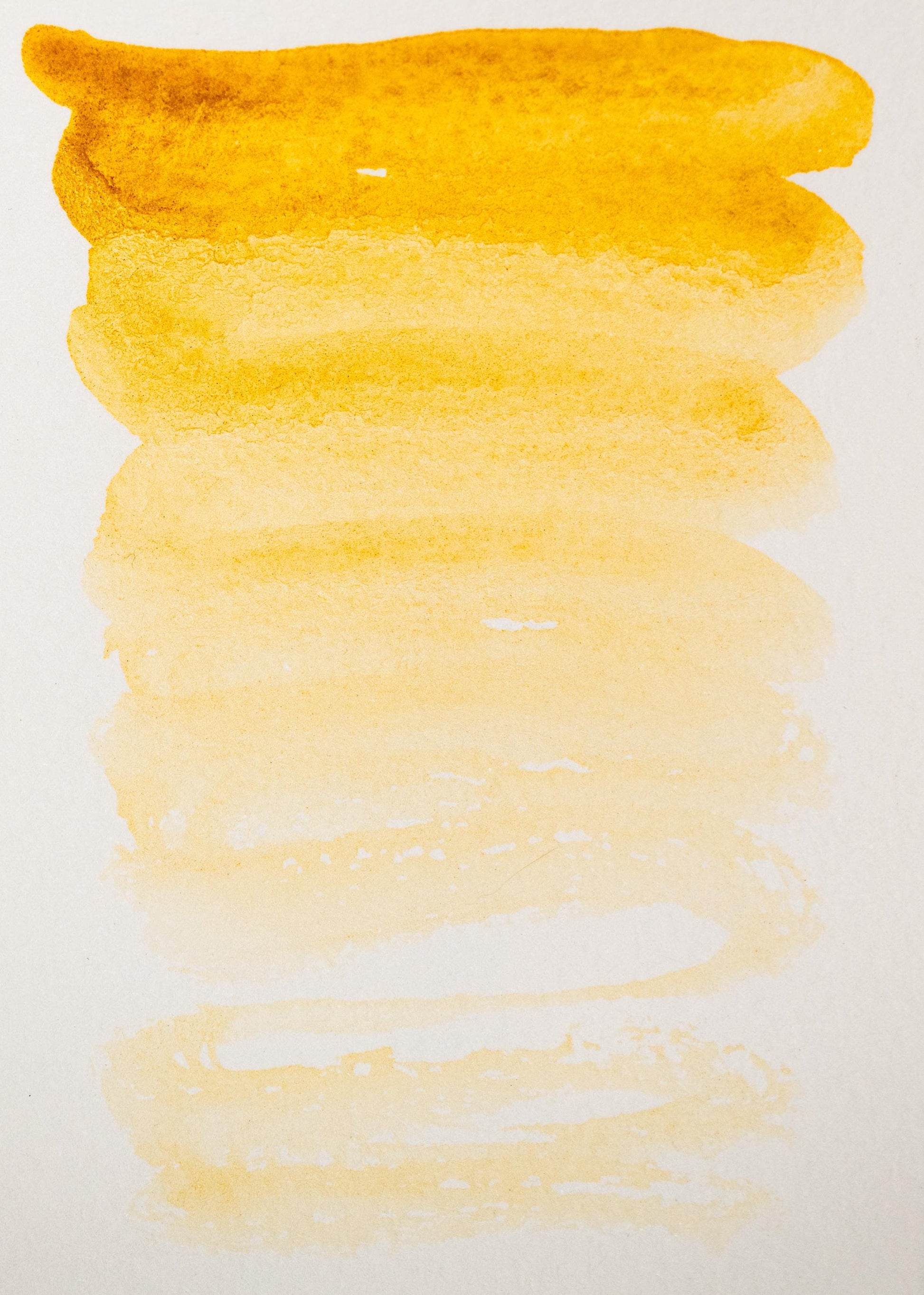 Golden earth swatch of Yellow Ochre ink, fading from bold ochre to a soft wheat tone. This traditional mineral pigment provides warm natural coverage with a matte finish, perfect for foundational washes and historical pigment-based artwork.