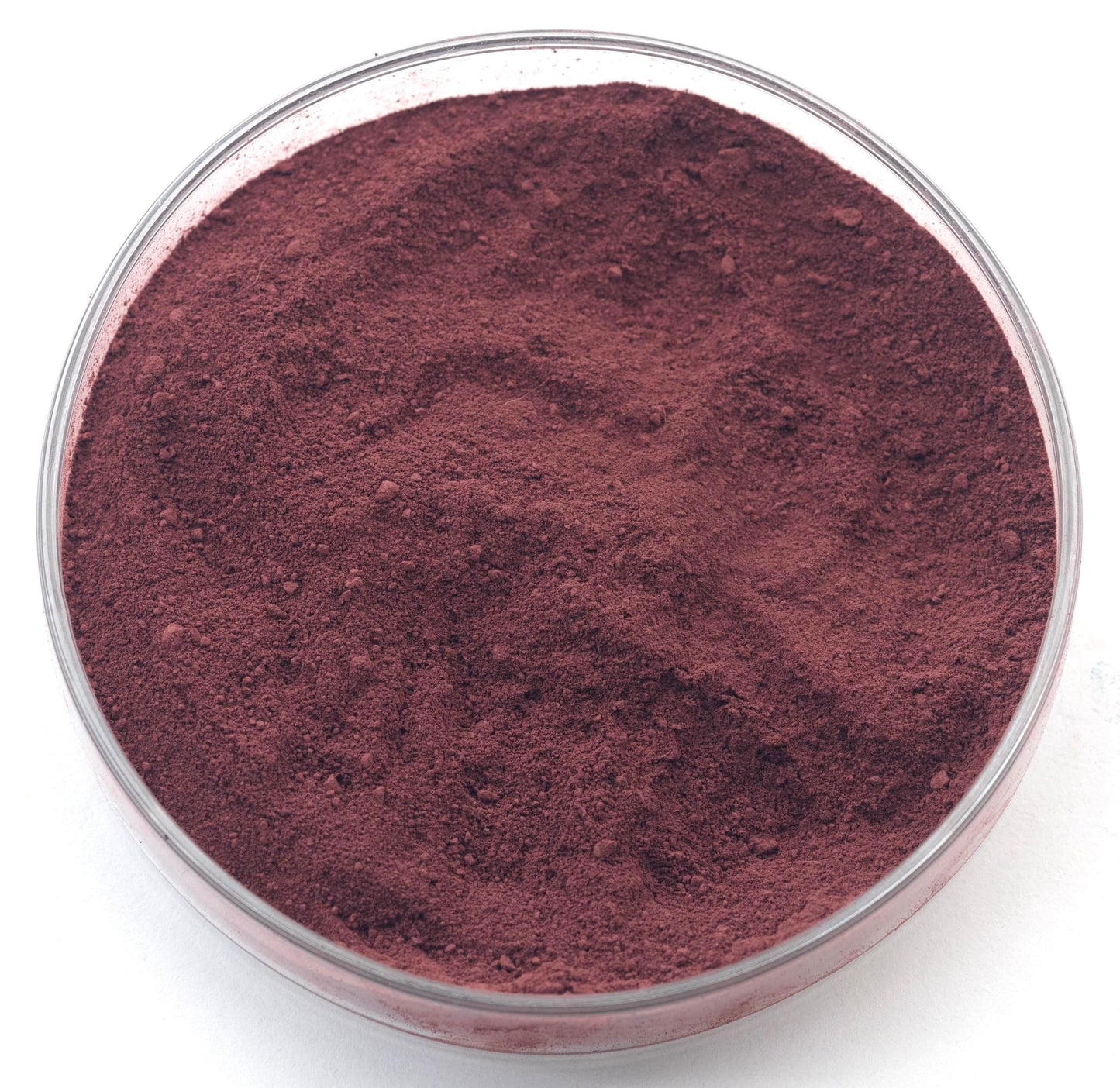 A glass bowl filled with a dark red powder substance.