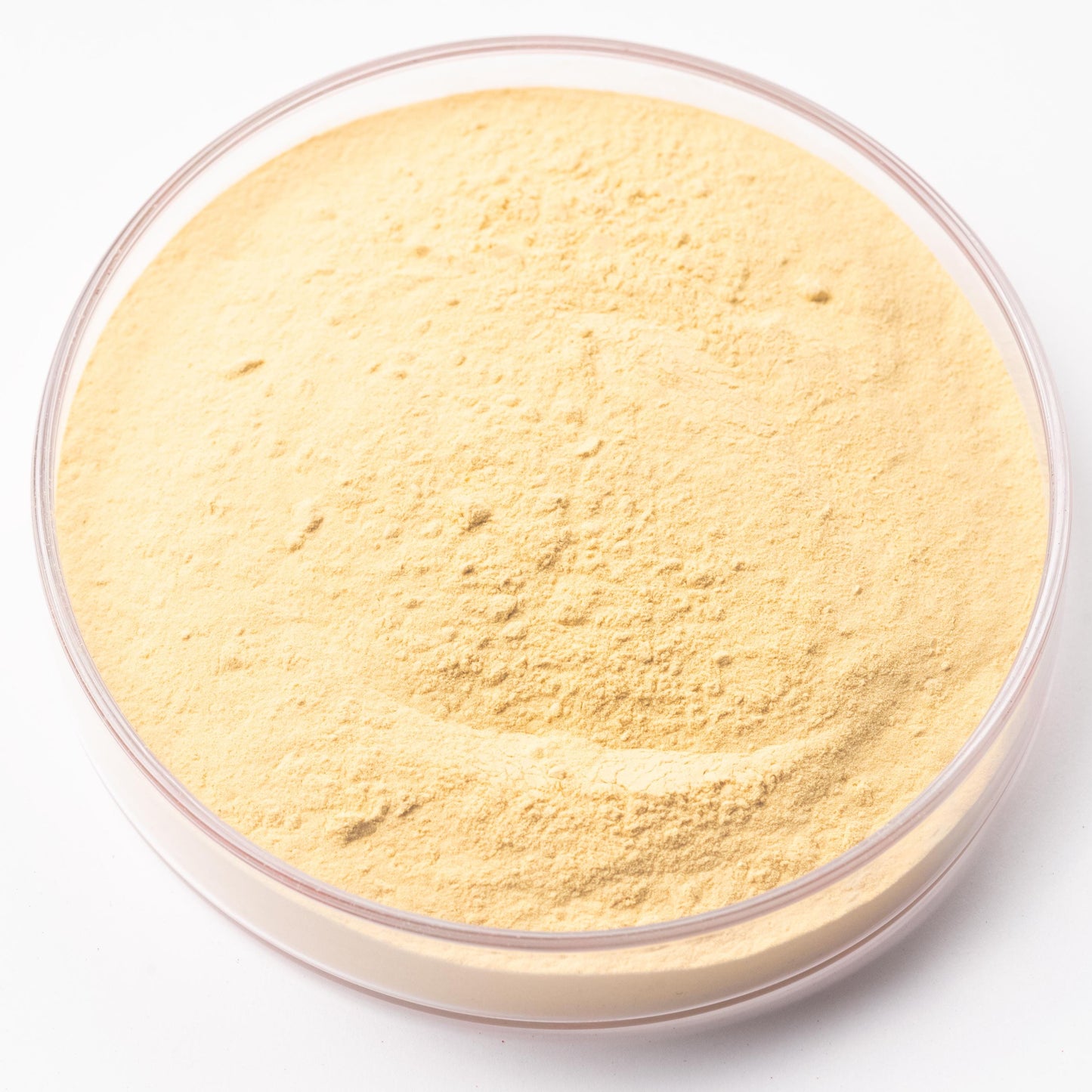 A transparent container filled with a yellow powder substance, possibly a powdered ingredient or product.