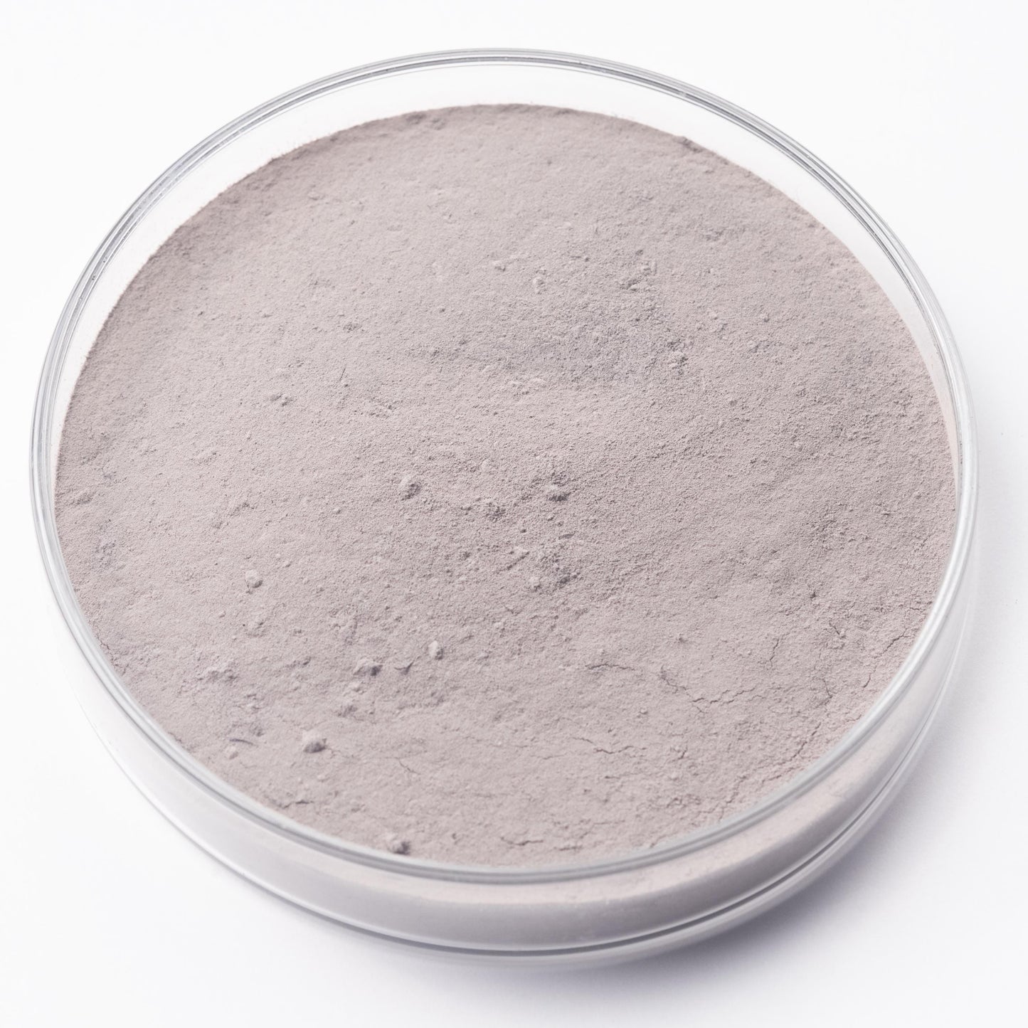 A clear glass container filled with a light brown substance, possibly a powdered material or a sample.