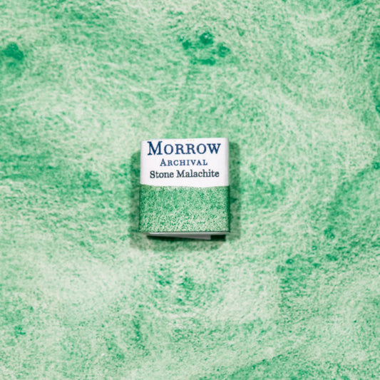 Watercolor painting with a handmade archival watercolor pan with elegant and vibrant label in watercolor paper in Natural Stone Malachite, a vibrant green pigment ground from the semi-precious copper carbonate mineral used since ancient Egypt for art, cosmetics, and protective amulets. Handcrafted with honey and gum arabic. Semi-opaque and lightfast, ideal for icon painting, mineral-based palettes, and historical landscape work.