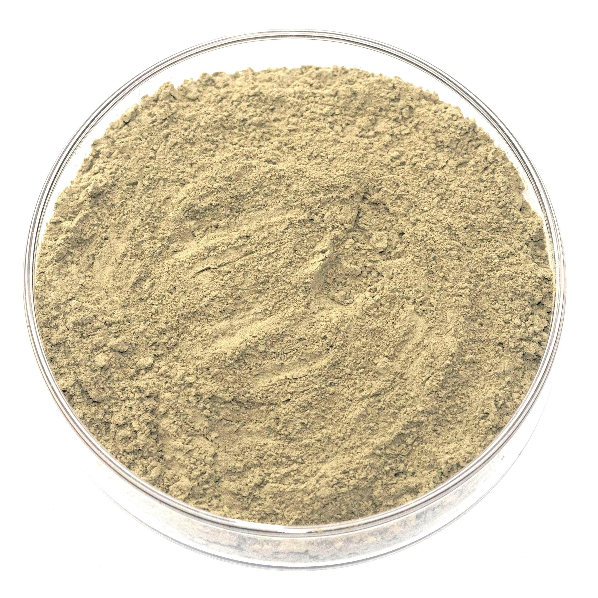 A glass bowl filled with a light brown substance, possibly a type of powder or granular material.