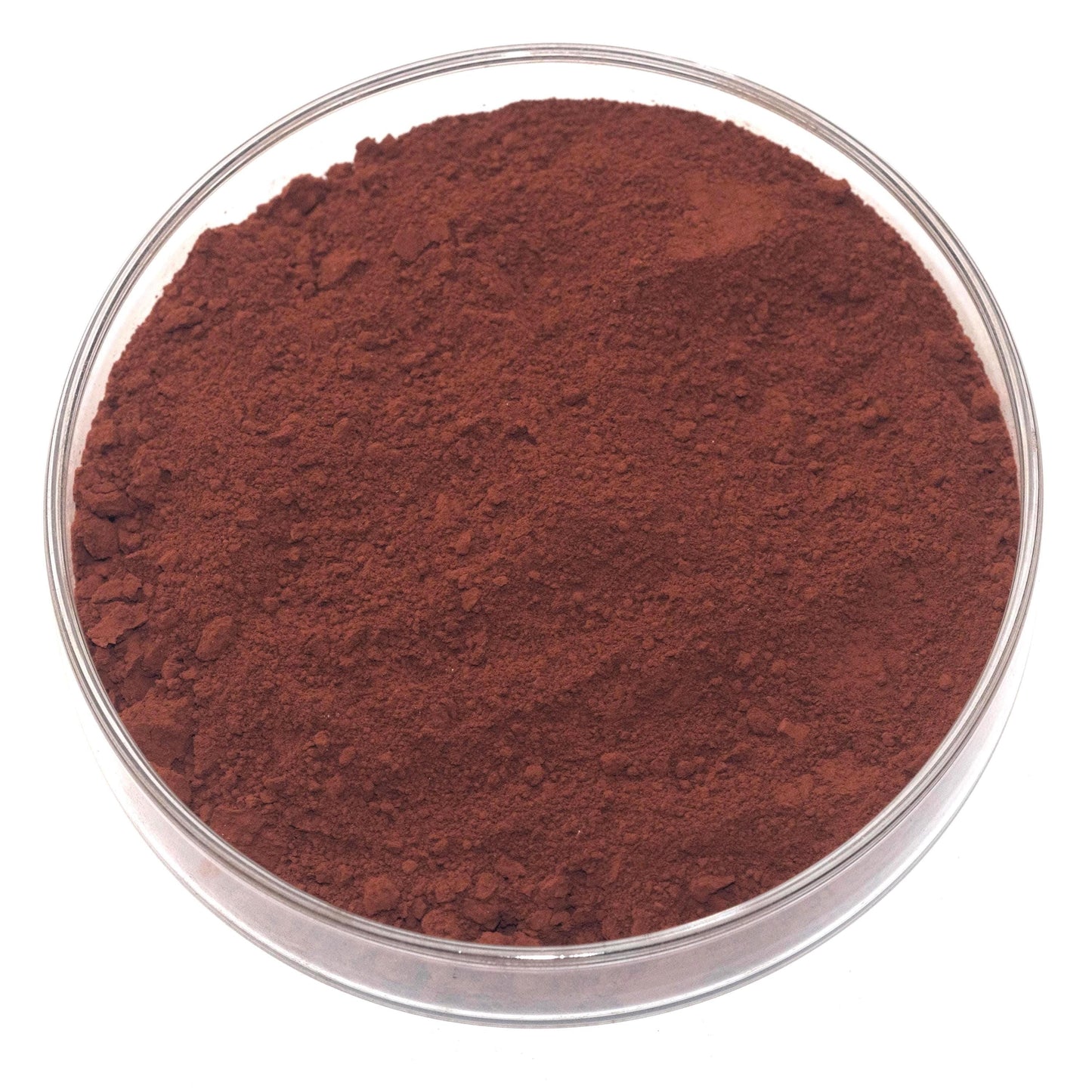 A glass bowl filled with a dark brown, reddish-brown substance, possibly a type of soil or soil sample.
