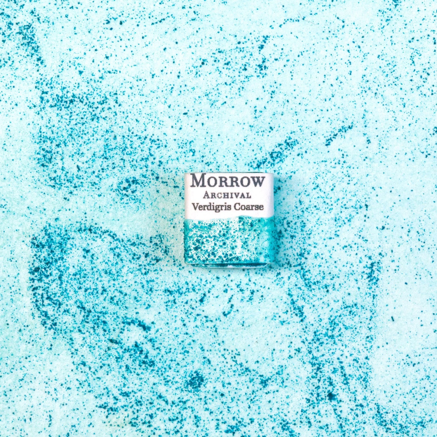 Close-up image of a half pan of Verdigris handmade watercolor paint, featuring a soft, blue-green hue with delicate granulation and a translucent finish. The pan rests on a neutral background, highlighting the pigment‚Äôs historic character and artisanal craftsmanship. Ideal for artists seeking a luminous, antique green with classical and botanical appeal.