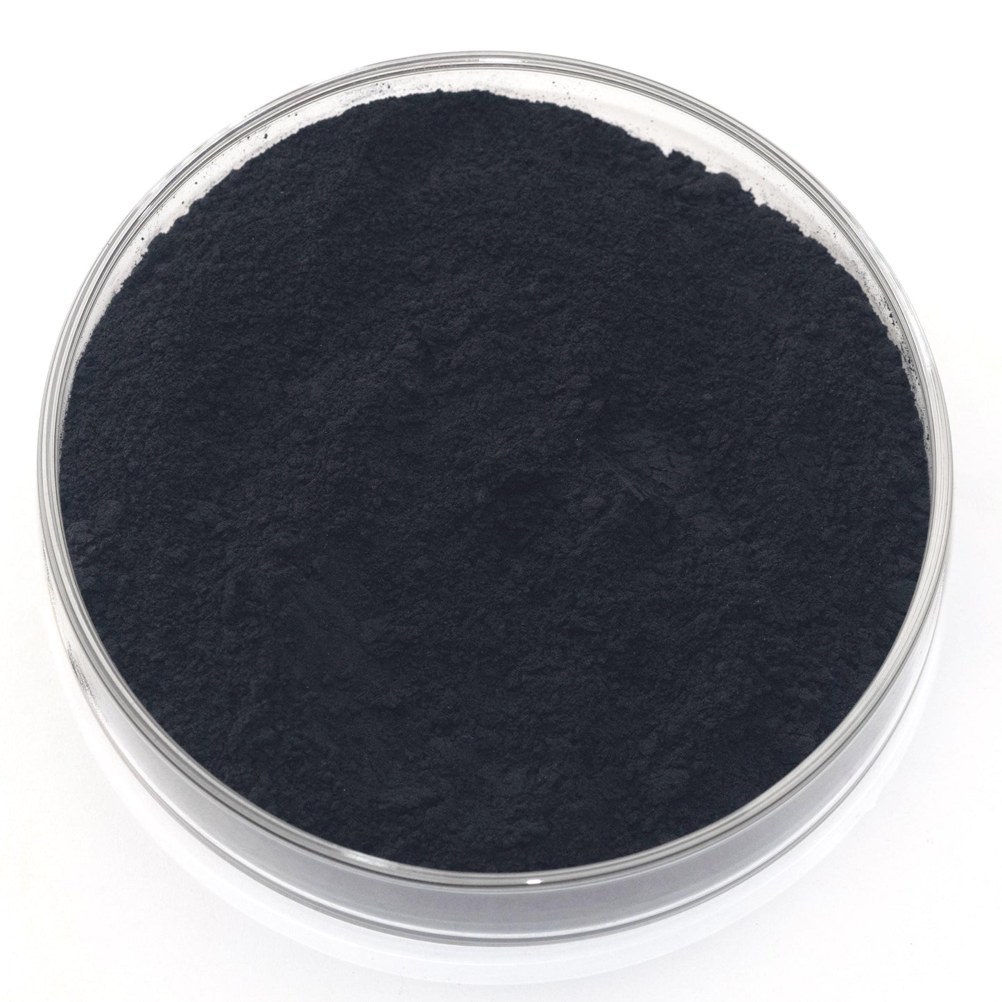 A glass container filled with a dark, powdery substance, possibly a type of carbonate or carbonate compound.