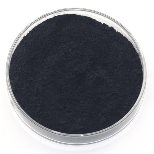 A glass container filled with a dark, powdery substance, possibly a type of carbonate or carbonate compound.