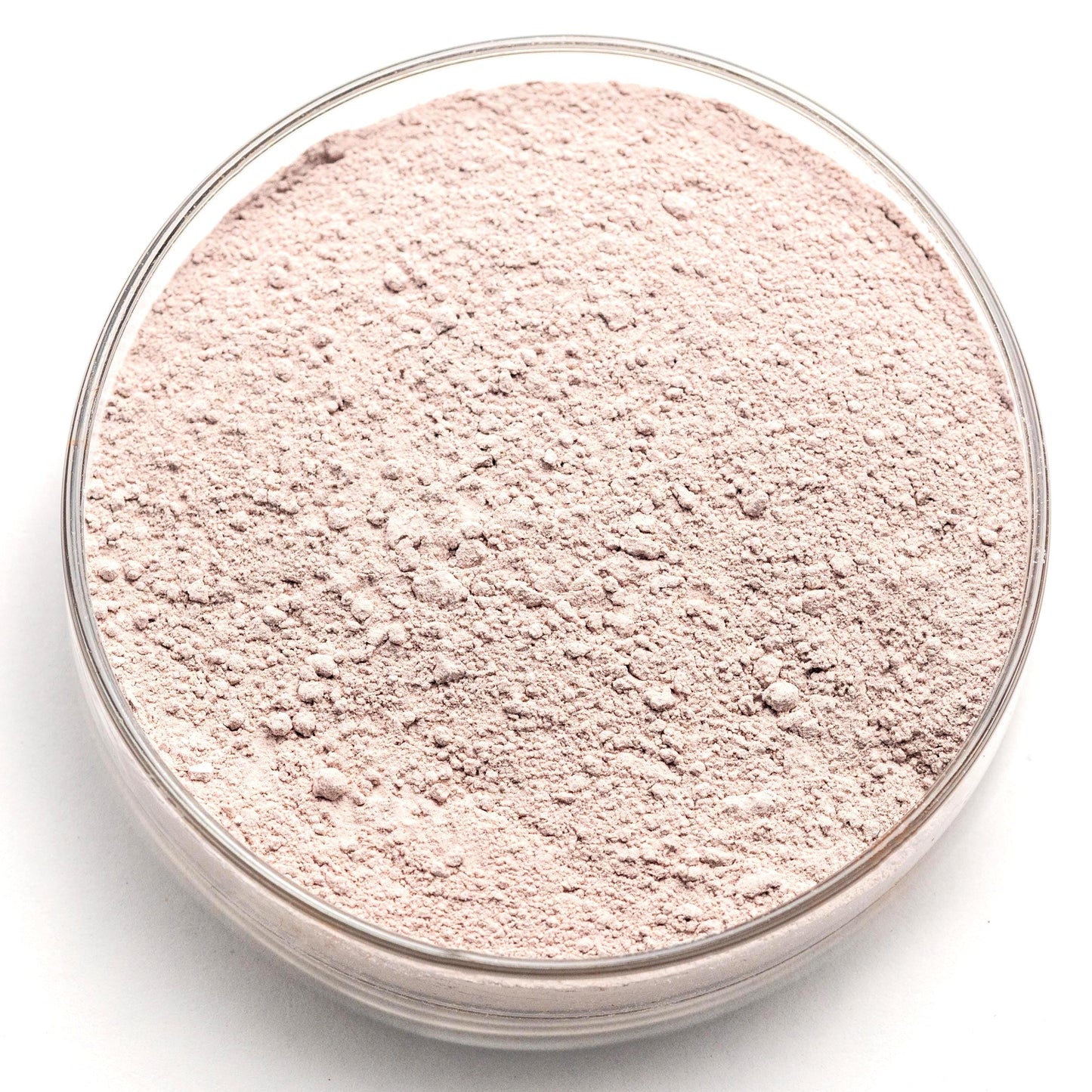 A glass bowl filled with a light pink, powdery substance, possibly a type of flour or seasoning.