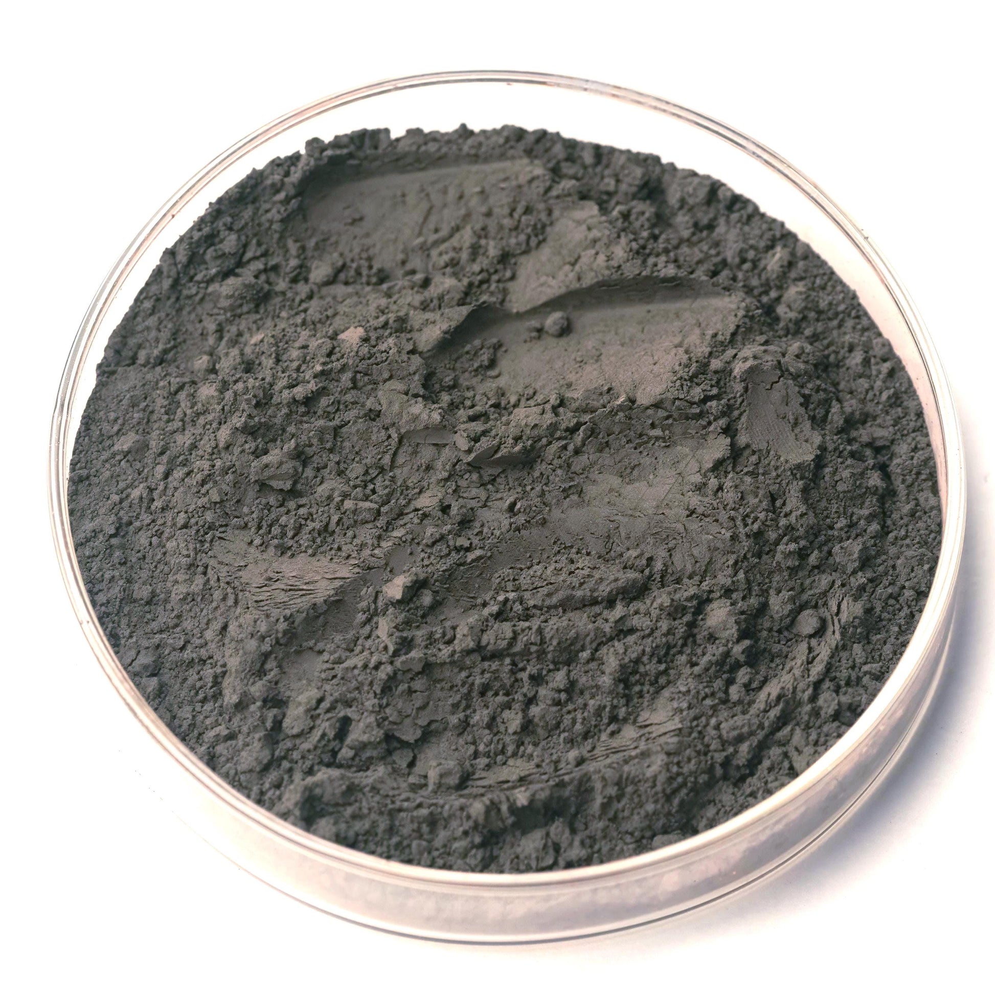Gray powder in a clear glass container on a white background