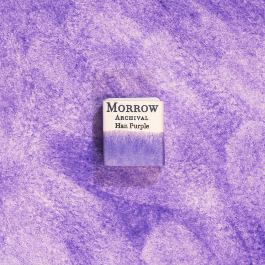 Handmade Han Purple natural watercolor paint half pan displayed on a textured watercolor painting. Crafted from pure single-pigment synthetic purple inspired by ancient Chinese pigment technology, offering vivid violet tones perfect for fine art, historical illustration, and restoration work. An exceptional eco-friendly gift for watercolor artists, history lovers, and collectors who value small-batch, archival-quality, all-natural handmade pigments.