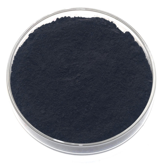 A glass bowl containing a dark, powdery substance, which appears to be a type of black powder or substance.