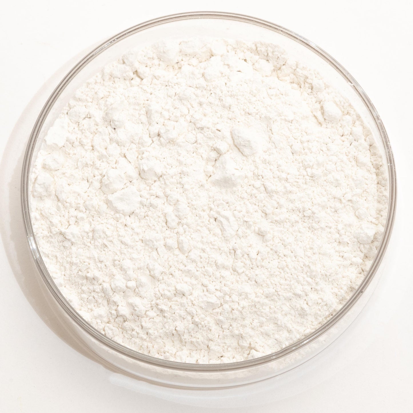 A glass bowl filled with a white powder substance, likely flour or cornstarch, is shown in the image.