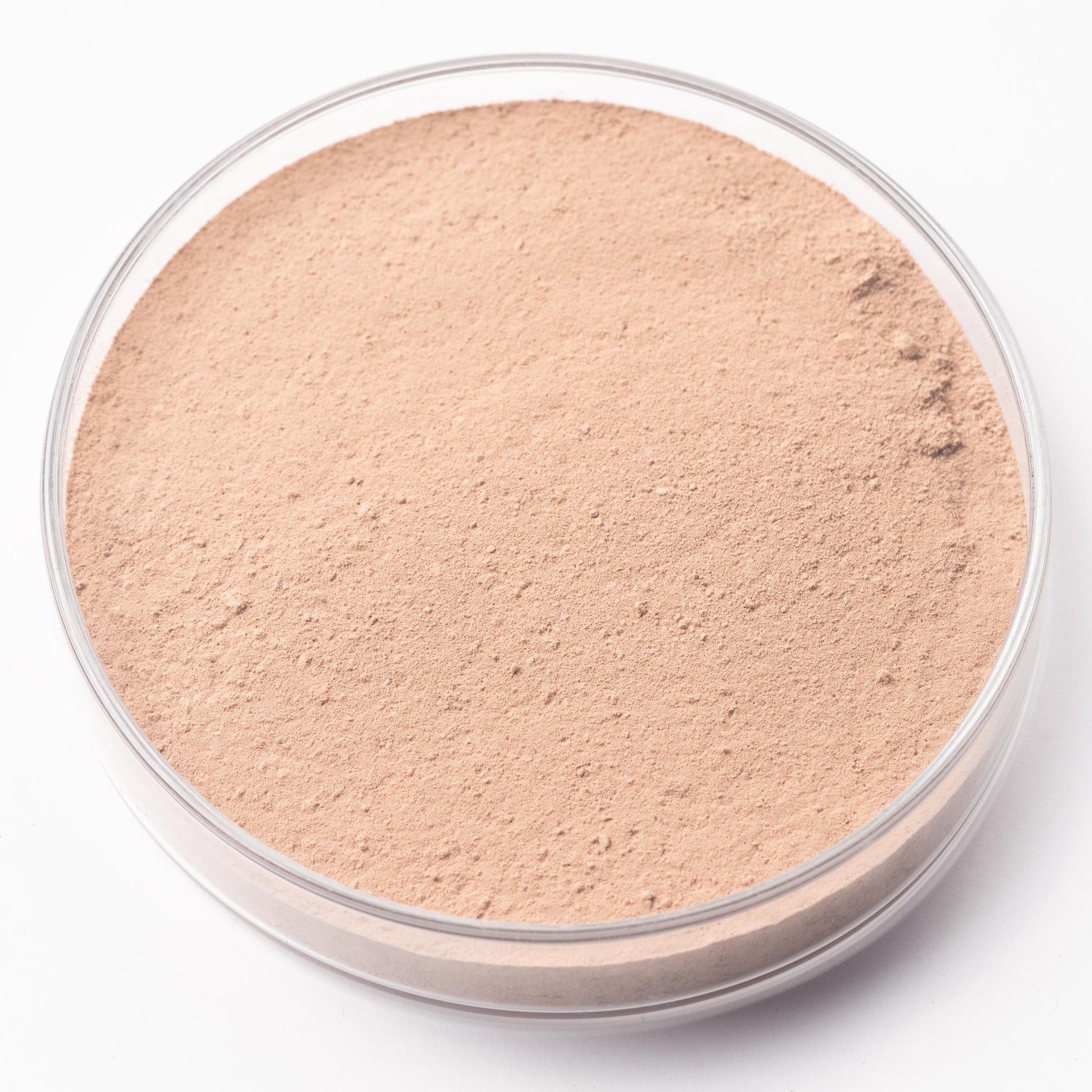 A round glass container filled with a light brown powder substance.