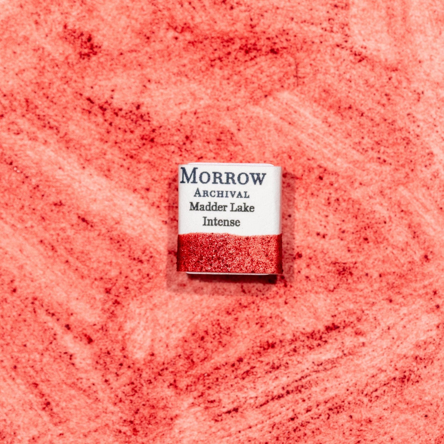 Watercolor painting with a hand made archival watercolor pan with elegant and vibrant label in watercolor paper in soft rose Madder Lake Intense, a delicate version of madder root pigment (Rubia tinctorum), historically used for fine glazes and portrait work. Handcrafted with honey and gum arabic. Transparent and lightfast, ideal for botanical illustration, soft pink tones, and traditional European palettes.