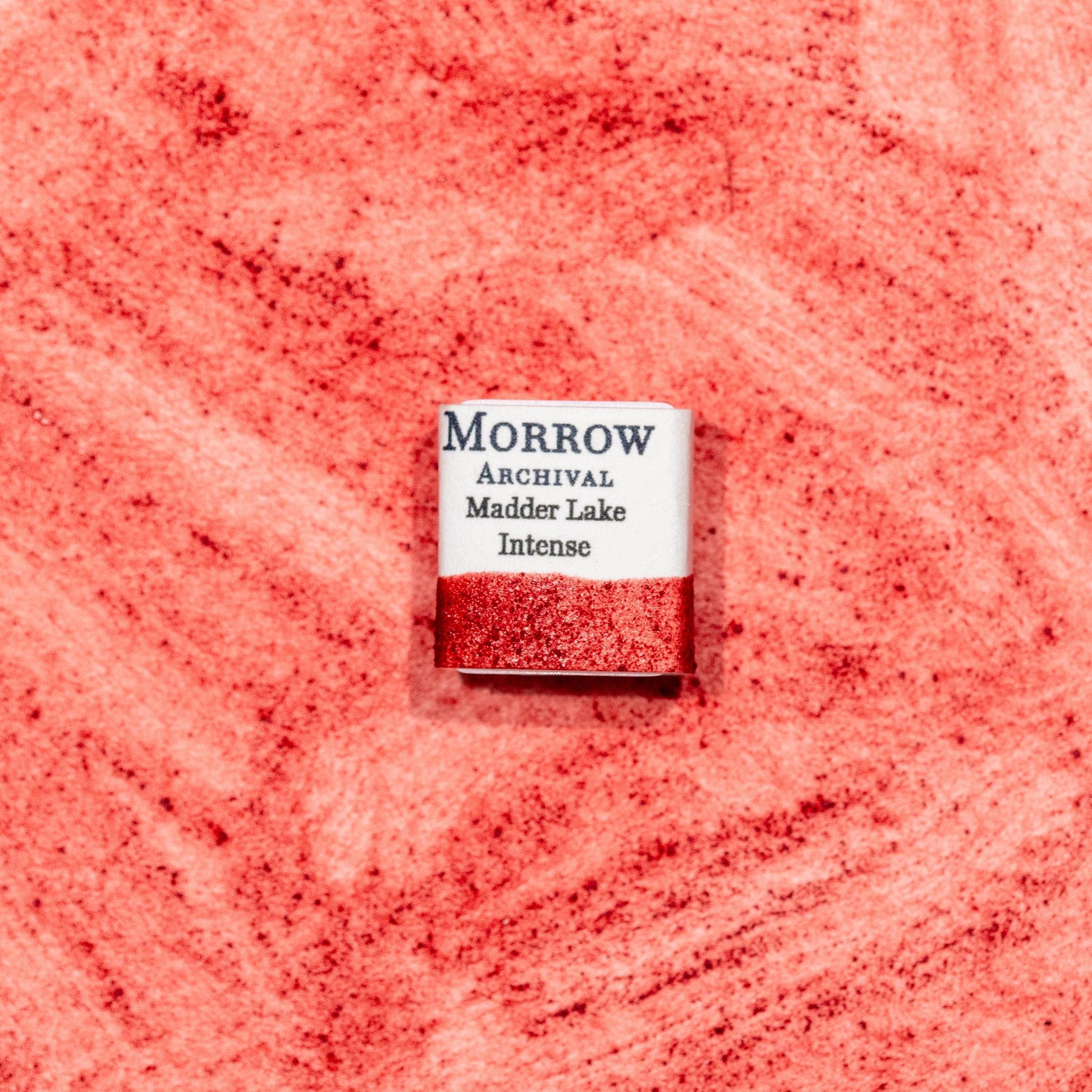 Watercolor painting with a hand made archival watercolor pan with elegant and vibrant label in watercolor paper in soft rose Madder Lake Intense, a delicate version of madder root pigment (Rubia tinctorum), historically used for fine glazes and portrait work. Handcrafted with honey and gum arabic. Transparent and lightfast, ideal for botanical illustration, soft pink tones, and traditional European palettes.