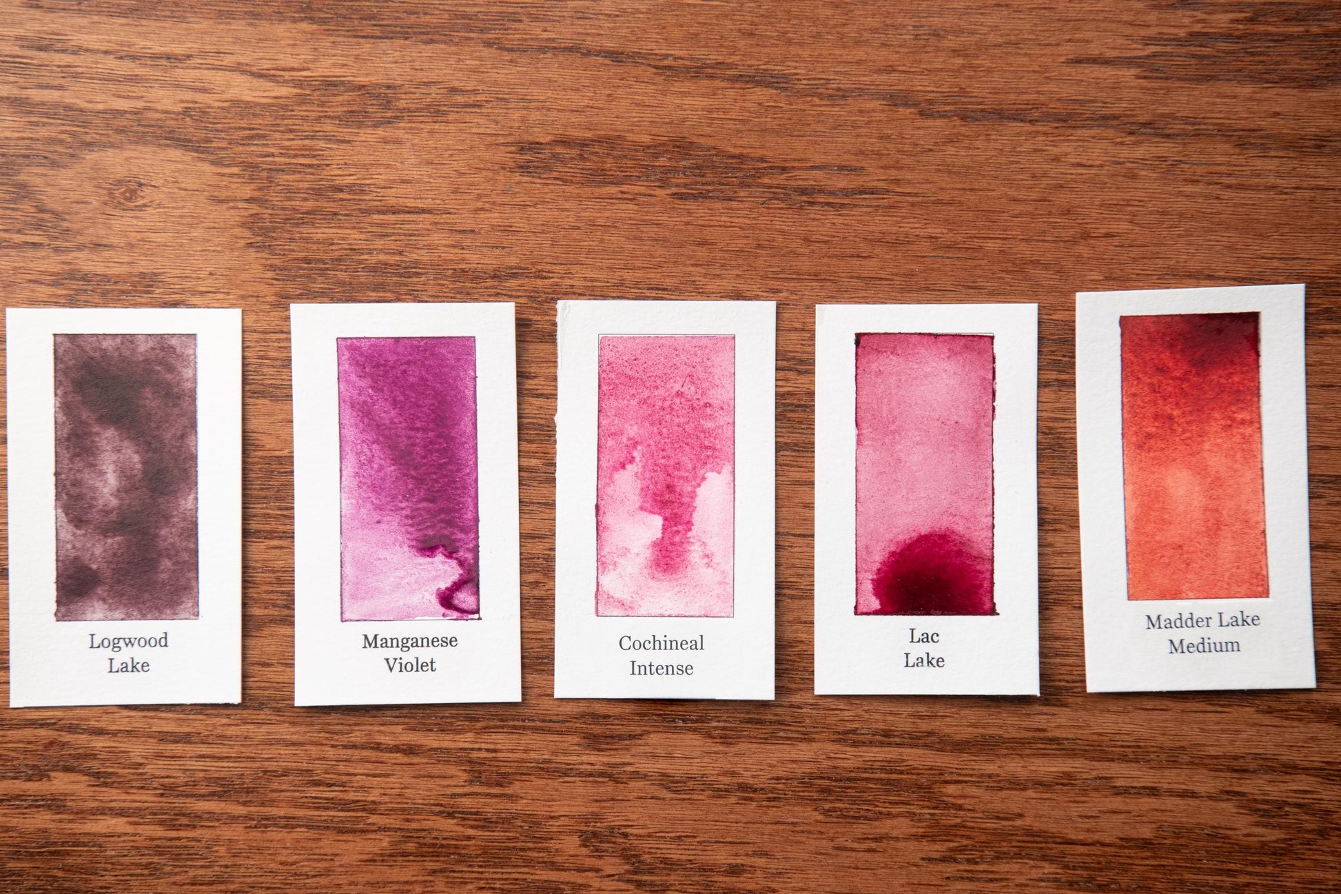 five watercolor paintings with different intensity levels, each labeled with a name.