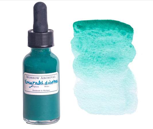 Emerald Dioptase watercolor ink by Morrow Archival, handmade from genuine mineral pigment for a vivid blue-green hue with sparkling depth. Shown in a glass dropper bottle beside a rich emerald-toned wash on watercolor paper. This rare, all-natural stone-based ink offers vibrant transparency and granulation, perfect for fine art, historical palettes, and collectors seeking high-performance, ethically sourced pigments.