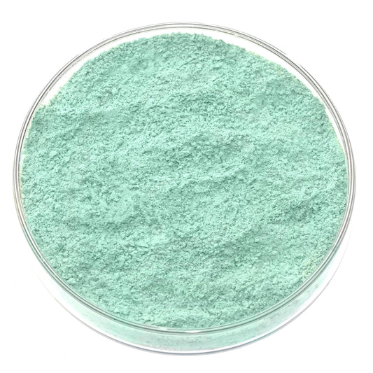 A clear petri dish filled with fine Cypriot Celadonite Green Earth Pigment, showing its light mint-green hue from above against a white background—a stunning natural green earth for handmade artists pigment.