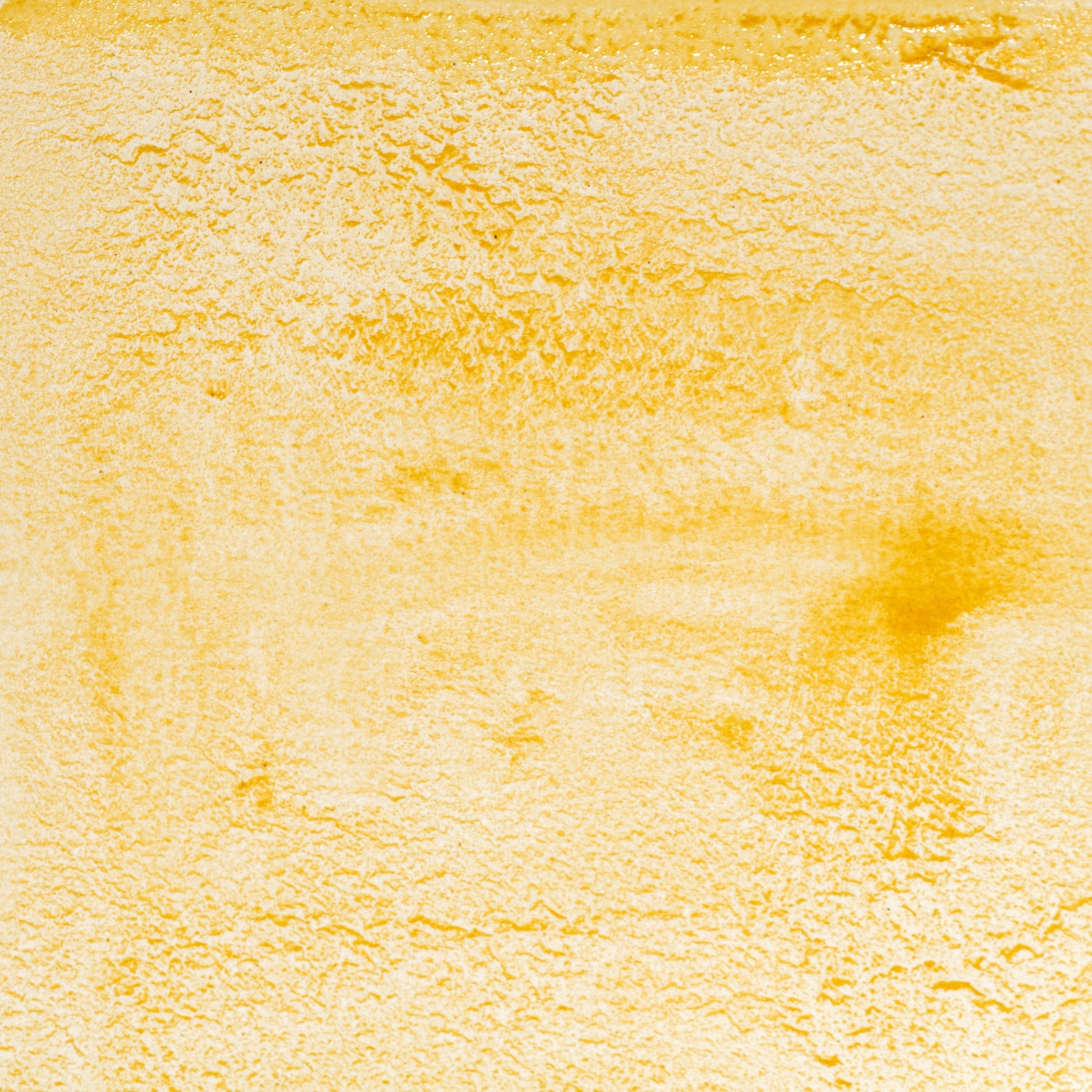 Watercolor swatch in Yellow Travertine, a natural earth yellow pigment ground from iron-rich travertine limestone, echoing the warm tones of ancient Roman architecture and frescoes. This handmade watercolor is crafted with honey and gum arabic, offering semi-opaque, lightfast color ideal for classical painting, historical reconstructions, and earthy, sunlit palettes.