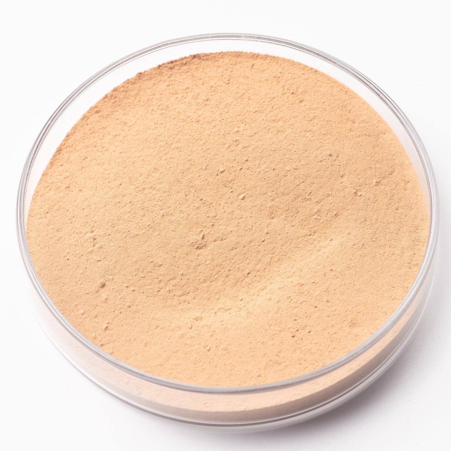 A clear glass container filled with a light brown powder substance.