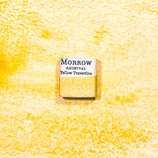 Watercolor painting with a handmade archival watercolor pan with elegant and vibrant label in watercolor paper in Natural Stone Yellow Travertine, a soft, sun-washed yellow pigment ground from natural travertine limestone rich in iron oxide, echoing the tones of ancient Roman architecture and frescoes. Handcrafted with honey and gum arabic. Semi-opaque and lightfast, ideal for classical palettes, architectural sketches, and warm earth-toned compositions.