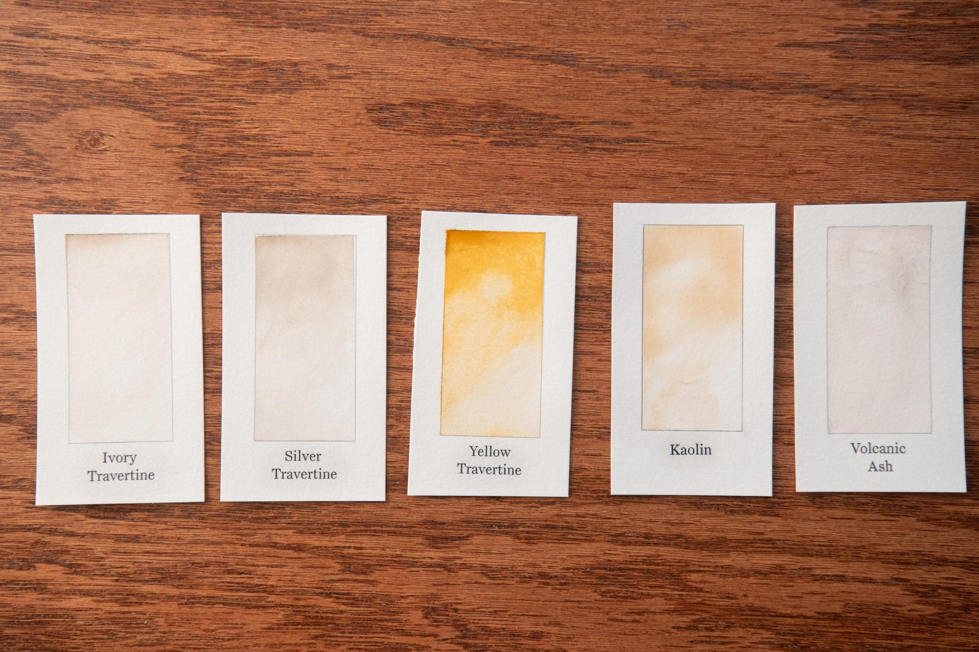 five different shades of travertine stone, each labeled with its name.