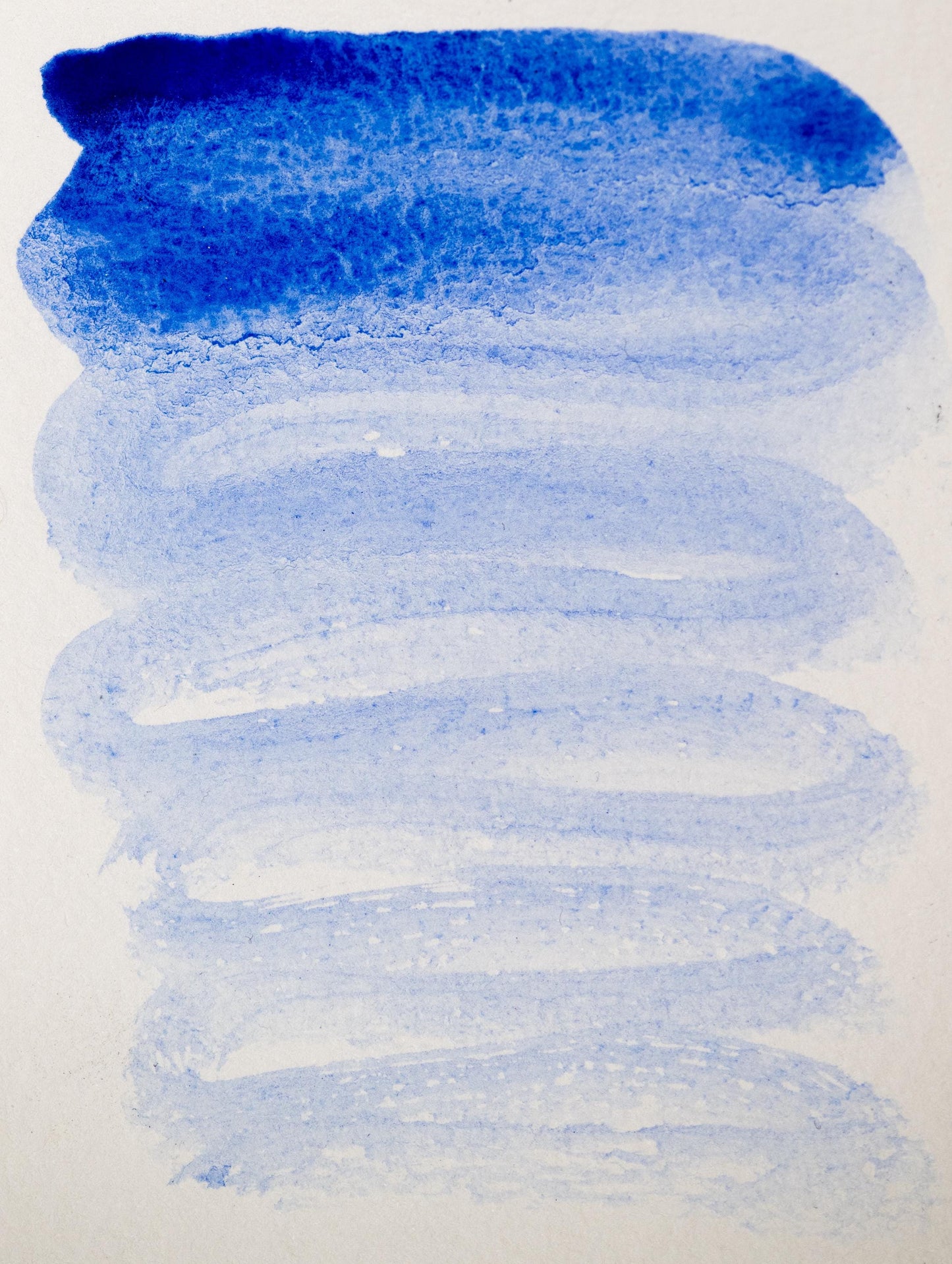 Historic swatch of natural Lapis Lazuli ink, featuring an ultramarine gradient with soft granulation. The color shifts from intense mineral blue to a translucent sky tone, capturing the beauty of ground semi-precious stone in watercolor form.