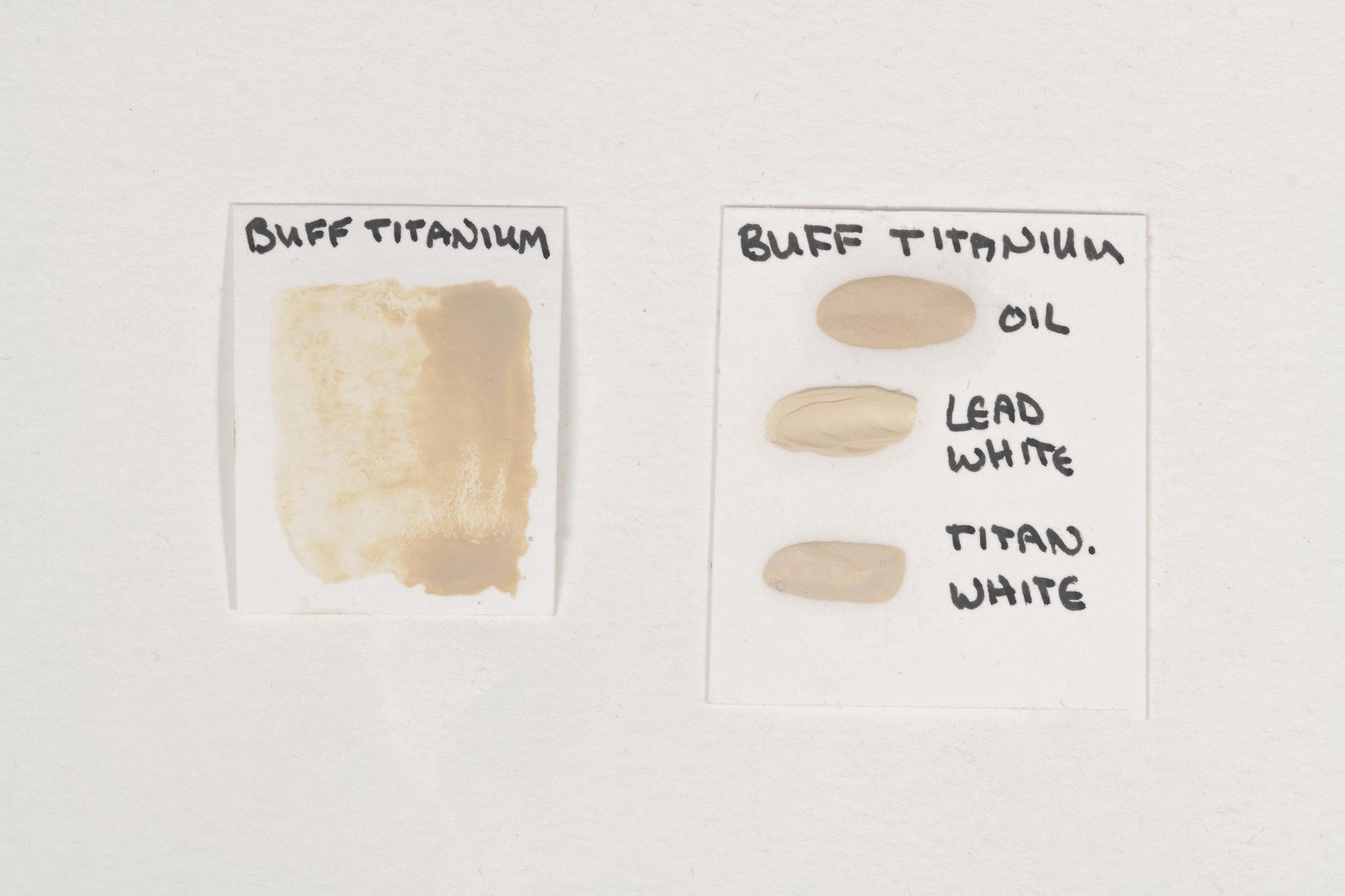 Buff Titanium pigment tested in watercolor using honey, in oil, and mixed with tints of titanium white and lead white. The image showcases its warm, creamy off-white hue, soft opacity in watercolor, smooth blending in oil, and subtle tonal variations with white pigments. A naturally derived titanium dioxide pigment valued for its gentle tinting strength and use in soft, natural tones. High-quality Buff Titanium swatches displayed for comparison.