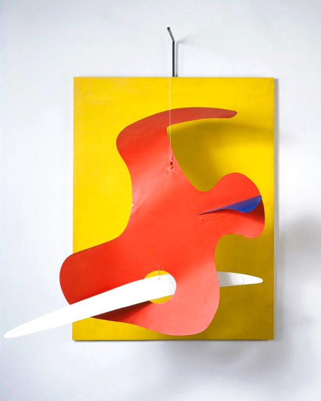 The artwork features a vivid yellow rectangular panel as the backdrop with a dynamic red form suspended in front. The red shape, curvaceous and organic, contrasts with the bright yellow, emphasizing movement and balance. From the red form, a white and blue element extends, contributing to the sense of dynamism and enhancing the three-dimensional aspect of the work.