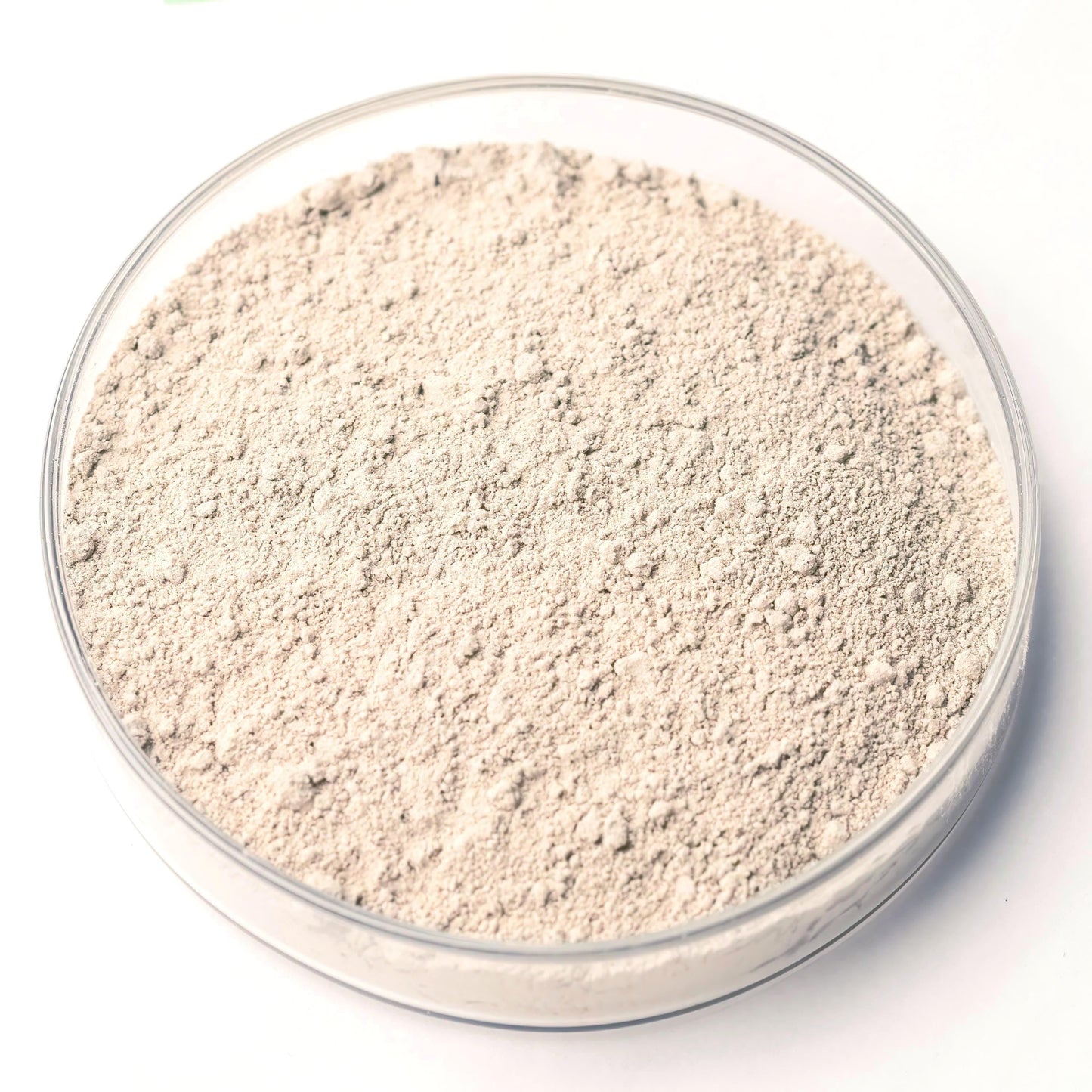 A glass bowl filled with a light-colored powder substance, possibly a type of seasoning or seasoning ingredient.