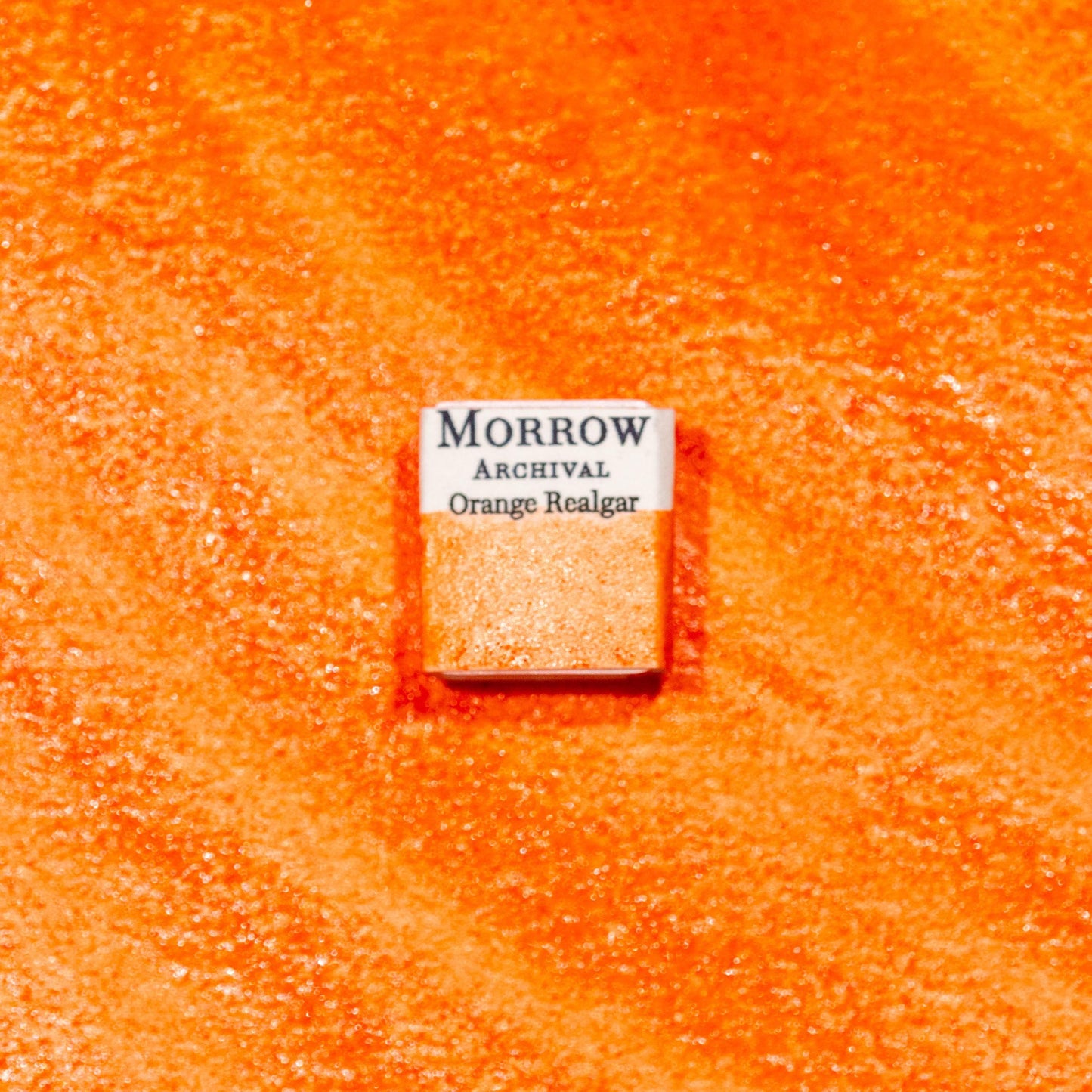 Watercolor painting with a handmade archival watercolor pan with elegant and vibrant label in watercolor paper in Natural Orange Realgar, a vivid orange-red pigment composed of arsenic sulfide (As‚ÇÑS‚ÇÑ), historically sourced from Chinese mineral deposits and used in manuscripts, alchemy, and ancient painting traditions. Handcrafted with honey and gum arabic. Opaque and moderately lightfast, ideal for medieval illumination, bold accents, and historically accurate warm palettes.