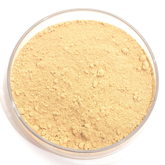A glass bowl filled with a light brown, crumbly substance, possibly a type of flour or seasoning.