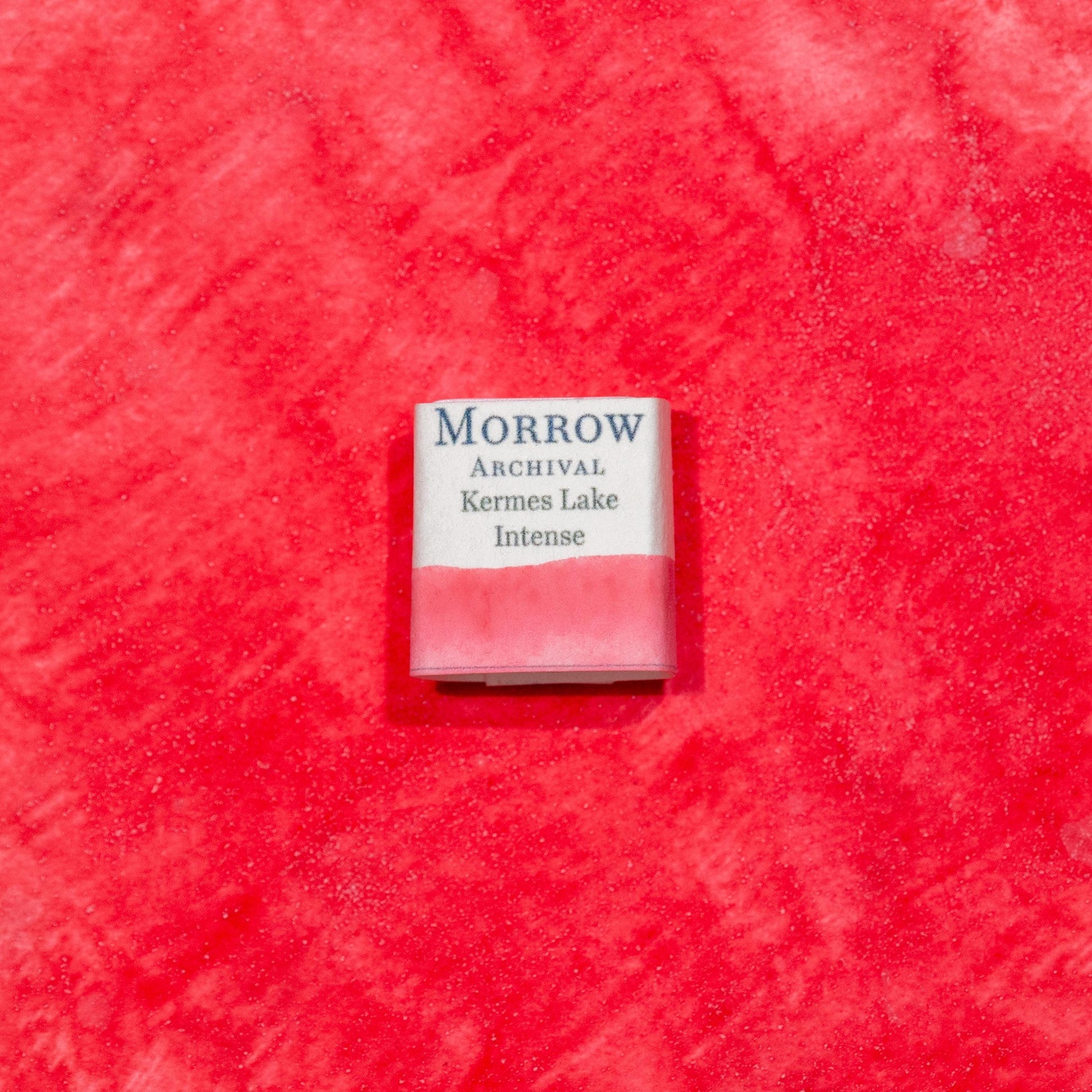 Watercolor painting with a handmade archival watercolor pan with elegant and vibrant label in watercolor paper in Kermes Lake, a rich crimson pigment made from the Kermes insect (Kermes vermilio), one of the earliest known sources of red dye in the Mediterranean and Middle East. Handcrafted with honey and gum arabic. Transparent and historically lightfast, ideal for manuscript illumination, medieval European palettes, and deep crimson glazes.