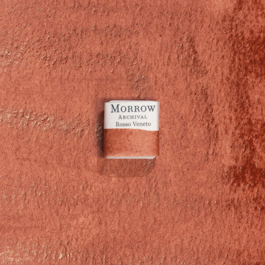 Handmade Rosso Veneto Red Earth natural watercolor paint half pan displayed on a textured watercolor painting. Crafted from pure single-pigment red earth sourced from northern Italy, this warm, deep red offers soft granulation and rich transparency, perfect for classical painting, botanical art, and historical illustration. A timeless eco-friendly gift for watercolor artists and collectors seeking small-batch, archival-quality, all-natural handmade pigments with regional heritage.