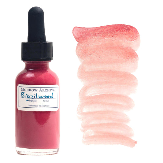 Historical medieval watercolor ink made with Brazilwood and Sappanwood Pink Lake pigment in a clear glass dropper bottle, labeled with high-quality watercolor paper and a hand-applied swatch. This organic, natural ink has a rich rose-pink hue with subtle warmth and depth. The swatch beside the bottle displays the ink’s fluidity and gradient from deep magenta to soft blush. Archival quality, ideal for calligraphy, illumination, and historical painting.